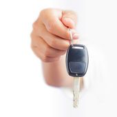 Image of a hand holding a car key.